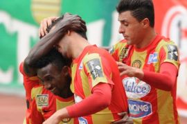 Esperance of Tunis players hug their teammate Striker Hayhem Juini (C) after to scoring against Kenya's Gor Mahia FC during their CAF Champions League football match, at the Olympic Stadium in Rades, on March 10, 2014. AFP PHOTO/FETHI BELAID