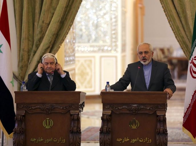 Iranian Foreign Minister Mohammad Javad Zarif (R) holds a press conference with his Syrian counterpart Walid Muallem in Tehran on December 8, 2014, ahead of a conference with their Iraqi counterpart on combating extremism. Iran is the main regional ally of Syrian President Bashar al-Assad, and Tehran has acknowledged sending military advisers to assist his forces in their fight against armed rebels and jihadist militants. AFP PHOTO/ ATTA KENARE