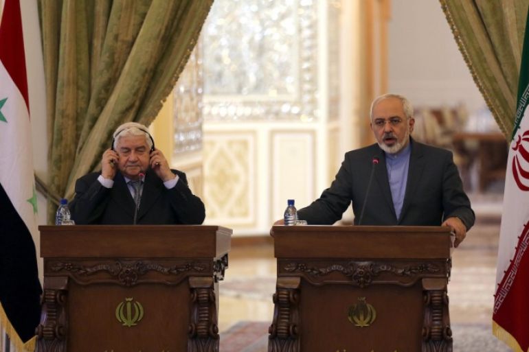 Iranian Foreign Minister Mohammad Javad Zarif (R) holds a press conference with his Syrian counterpart Walid Muallem in Tehran on December 8, 2014, ahead of a conference with their Iraqi counterpart on combating extremism. Iran is the main regional ally of Syrian President Bashar al-Assad, and Tehran has acknowledged sending military advisers to assist his forces in their fight against armed rebels and jihadist militants. AFP PHOTO/ ATTA KENARE