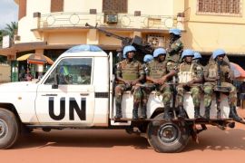 UN peacekeeping soldiers from Rwanda patrol on December 09, 2014 in Bangui. The UN peacekeeping mission currently counts 8,600 people on the ground, and plans to increase this number to 12,000. AFP PHOTO / Pacome PABANDJI