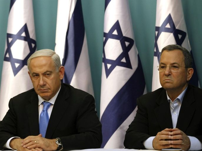 Israeli Prime Minister Benjamin Netanyahu sits next to Defence Minister Ehud Barak during a statement to the press at his Jerusalem office on November 21, 2012. Israel and Hamas agreed on a truce that will take effect this evening in a bid to end a week of bloodshed in and around Gaza that has killed more than 150 people, Egypt and the United States said.