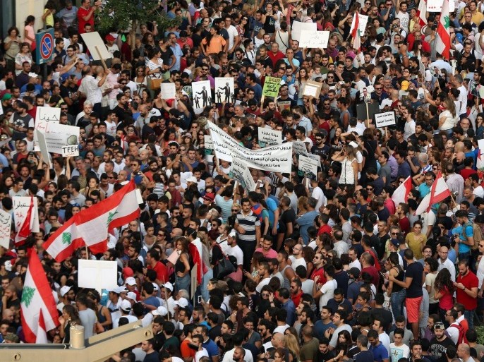 Activists, hold banners and chant slogans during a protest against the ongoing trash crisis, in downtown Beirut, Lebanon, Saturday, Aug. 22, 2015. Police have unleashed tear gas and water cannons on thousands of Lebanese demonstrating in downtown Beirut against government corruption and political dysfunction that has left garbage accumulating in the streets in suburbs of the capital for over a month. (AP Photo/Bilal Hussein)