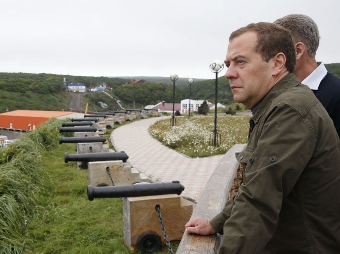001 - -, -, RUSSIAN FEDERATION : Russian Prime Minister Dmitry Medvedev inspects a port station in the Kitovyi village as he visits Iturup island, one of four islands in the chain that lies off Russia's far eastern coast and just north of Japan, on August 22, 2015. Russian Prime Minister Dmitry Medvedev landed Saturday in the Kuril islands, prompting a swift rebuke from Tokyo, which claims sovereignty over the northwest Pacific archipelago in a long-running dispute. AFP PHOTO / RIA NOVOSTI / DMITRY ASTAKHOV