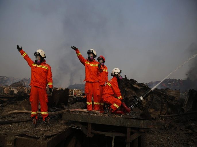 Firemen wearing gas masks combat fresh fires in the area of a huge explosion that rocked the port city of Tianjin, China, 15 August 2015. Explosions and a fireball at a chemical warehouse killed at least 85 people in the north-eastern Chinese port city of Tianjin late on 12 August. New explosions rocked a chemical warehouse in northern China as police ordered residents to evacuate buildings within a three-kilometre radius, state media said on 15 August.