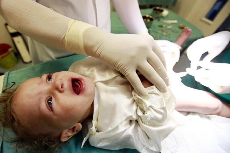 A boy cries as he is circumcised at Birtraria Hospital in Algiers September 5, 2010. Muslim boys aged between 2 - 5 years old are commonly circumcised a day before Laylat Al Qadr (the holiest night of Ramadan), as part of a religious tradition in Algeria.