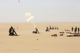 Saudi soldiers fire artillery towards the border with Yemen in Najran, Saudi Arabia, Tuesday, April 21, 2015. (AP Photo/Hasan Jamali)