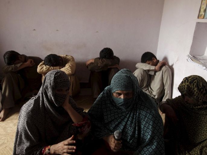 Children whose families say have been abused, hide their faces while their mothers are interviewed by a Reuters correspondent in their village of Husain Khan Wala, Punjab province, Pakistan August 9, 2015. Parents at the centre of a growing child abuse scandal in Pakistan have accused police of failing to do enough to break up a paedophile ring in Punjab province, the prime minister's political heartland. Accounts of abuse in Husain Khan Wala were splashed across the front pages of Pakistani newspapers over the weekend, and Prime Minister Nawaz Sharif is expected to be questioned on the topic in parliament on Monday. Villagers told Reuters on Sunday that a prominent family there has for years forced children to perform sex acts on video. The footage was sold or used to blackmail their impoverished families. Picture taken August 9, 2015. REUTERS/Mohsin Raza TPX IMAGES OF THE DAY