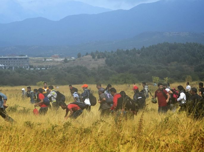 Migrants who waited more then 48 hours on the Greek side of the border line, flee across a field after jumping over razor wire to cross into Macedonia near southern city of Gevgelija, The Former Yugoslav Republic of Macedonia, 22 August 2015.Macedonian special police forces arrived yesterday morning and blocked the illegal border crossing between Macedonia and Greece. They don't give permission to the migrants to pass in Macedonia. Macedonian government has declared emergency situation in the south and north border with Greece and Serbia due to rising number of migrants and fugitives from Syria, Afganistan, Iraq, Pakistan and Somalia. From the beginning of the year to mid-June 2015, nearly 160,000 migrants landed in the southern European countries, mainly Greece and Italy, on their way to wealthier countries in Western and Northern Europe, according to estimates by the International Organization for Migration (IOM).