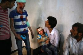 Wounded Syrians wait at a make shift hospital in the rebel-held area of Douma, east of the capital Damascus, following shelling and air raids by Syrian government forces on August 22, 2015. At least 20 civilians and wounded or trapped 200 in Douma, a monitoring group said, just six days after regime air strikes killed more than 100 people and sparked international condemnation of one of the bloodiest government attacks in Syria's war. AFP PHOTO / ABD DOUMANY