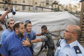 An Israeli border guard pushes back Bentzi Gopstein (2nd from L), the leader of the extremist anti-Arab group Lehava, as he and other members tried to jump a barrier to cross into the al-Aqsa mosque compound, Islam's third holiest site and also the most sacred spot for Jews who refer to it as the Temple Mount, in the old city of Jerusalem after Israeli authorities temporarily closed the compound. Israel's closure of the flashpoint Al-Aqsa mosque compound to all visitors following the shooting of a Jewish hardliner is tantamount to a 'declaration of war,' Palestinian president Mahmud Abbas said today. AFP PHOTO/JACK GUEZ