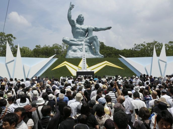 epaselect epa04877880 A crowd of people gathers around the Pace Prayer statue to offer prayers for victims killed by the atomic bombing of Nagasaki in 1945 after the 2015 Nagasaki Peace Ceremony at the Nagasaki Peace Park, in Nagasaki, south-western Japan, 09 August 2015. Nagasaki marks the 70th anniversary of the atomic bombing, killing about 74,000 people and injuring about 75,000 people of 240,000 population in 1945.