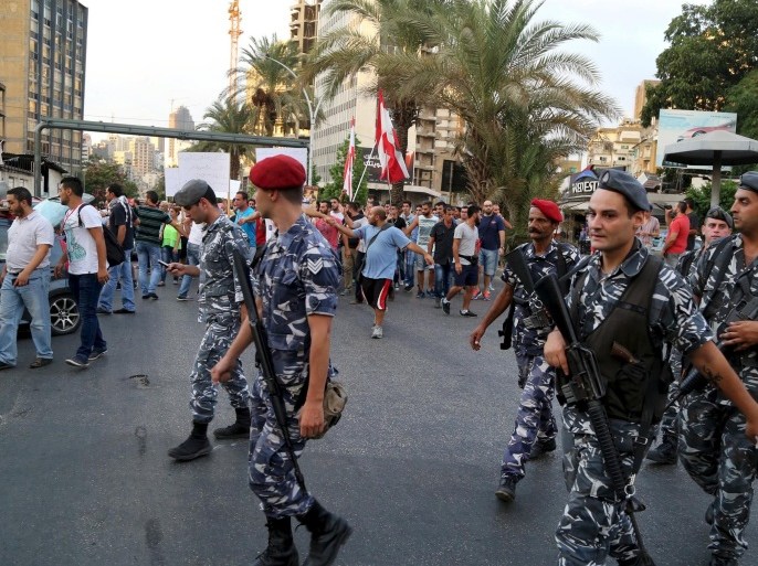 Members of security services escort demonstrators marching towards the government building Beirut, Lebanon August 24, 2015. Several hundred Lebanese protesters chanting anti-government slogans marched in central Beirut on Monday after two days of much larger rallies that descended into violence. REUTERS/Aziz Taher
