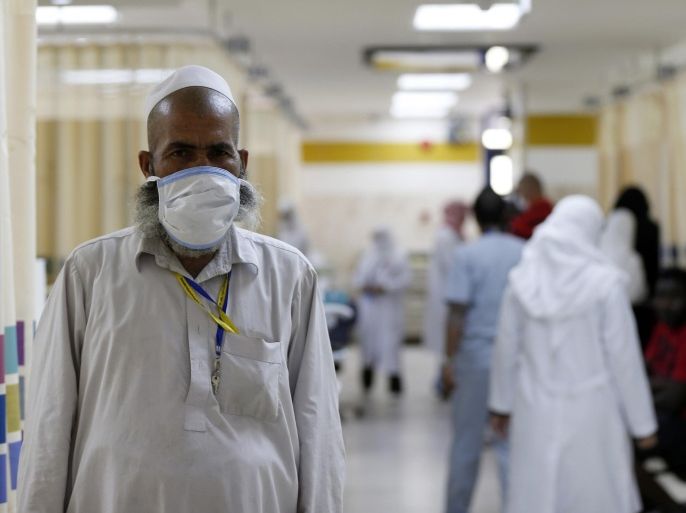 A Muslim pilgrim wears a protective mask in the emergency department at Al-Noor Specialist Hospital in Mecca September 30, 2014. According to hospital director Dr. Mohammad bin Omar, the hospital did not record any cases of pilgrims bearing the MERS coronavirus or Ebola virus entering Mecca for the Haj season, and that most of the cases referred to the hospital were of elderly patients with common ailments. REUTERS/ Muhammad hamed (SAUDI ARABIA - Tags: RELIGION HEALTH)
