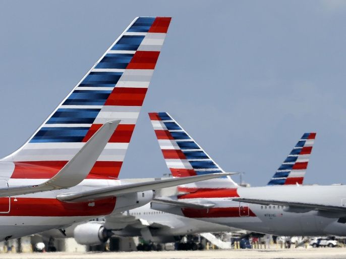 In this May 27, 2015, photo, American Airlines aircraft taxi at Miami International Airport in Miami. American Airlines reports quarterly financial results on Friday, July 24, 2015. (AP Photo/Lynne Sladky)