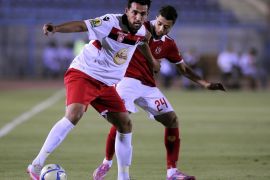 SUEZ, EGYPT - JULY 25: Basem Ali of Al-Ahly (R) in action against Yousef Al Moyhbel of Etoile Sportive du Sahel during the Confederation of African Football (CAF) Confederation Cup match between Etoile Sportive du Sahel and Al-Ahly at Suez Stadium in Suez, Egypt on July 25, 2015.