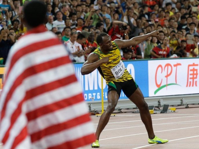 Jamaica's Usain Bolt strikes a pose for the cameras after winning the the men’s 100m final at theWorld Athletics Championships at the Bird's Nest stadium in Beijing, Sunday, Aug. 23, 2015. (AP Photo/Kin Cheung)