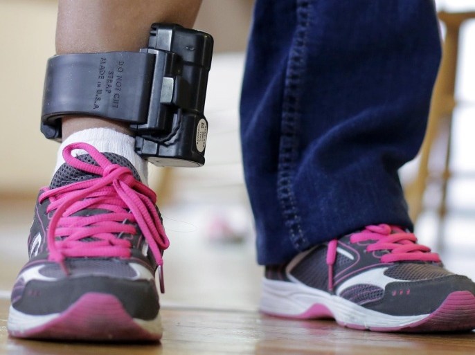 An immigrant from El Salvador that entered the country illegally wears an ankle monitor at a shelter, Monday, July 27, 2015, in San Antonio. Lawyers representing immigrant mothers held in a South Texas detention center say the women have been denied counsel and coerced into accepting ankle-monitoring bracelets as a condition of release, even after judges made clear that paying their bonds would suffice. (AP Photo/Eric Gay)