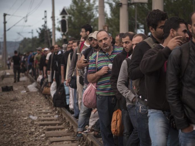 Syrian refugees wait near the the railway station of Idomeni , northern Greece to cross the border and enter Macedonia, on Monday Aug. 24, 2015. Greece has been overwhelmed this year by record numbers of migrants who have been arriving on a number of Greek islands.(AP Photo/Santi Palacios)