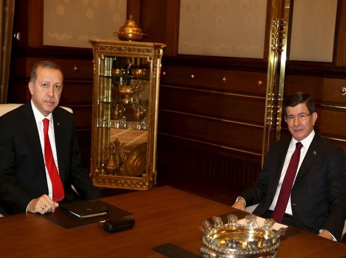 Turkish President Tayyip Erdogan (L) receives Prime Minister Ahmet Davutoglu at the Presidential Palace in Ankara, Turkey, August 25, 2015. Erdogan has called for fresh parliamentary elections, his office said on Monday, in a widely anticipated move after two months of coalition talks failed to produce a coalition government ahead of a deadline. Erdogan met Davutoglu on Tuesday and was expected to ask Davutoglu to form a temporary power-sharing government ahead of an election slated for Nov. 1. REUTERS/Yasin Bulbul/Presidential Palace Press Office/Handout via Reuters ATTENTION EDITORS - THIS PICTURE WAS PROVIDED BY A THIRD PARTY. REUTERS IS UNABLE TO INDEPENDENTLY VERIFY THE AUTHENTICITY, CONTENT, LOCATION OR DATE OF THIS IMAGE. FOR EDITORIAL USE ONLY. NOT FOR SALE FOR MARKETING OR ADVERTISING CAMPAIGNS. NO SALES. THIS PICTURE IS DISTRIBUTED EXACTLY AS RECEIVED BY REUTERS, AS A SERVICE TO CLIENTS.