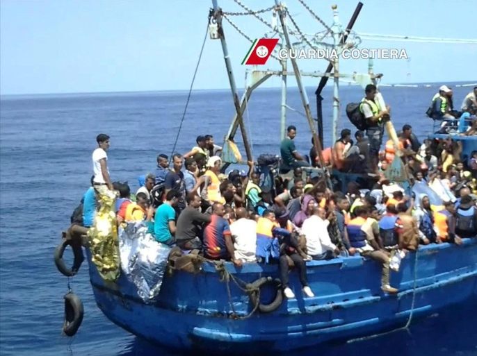 A handout image released by Italian Guard Coast on 23 August 2015 of migrants overcrowding a boat off the Italian coast in the Mediterranean Sea, 22 August 2015. At least 4,000 migrants are being rescued in several large-scale operations in the central Mediterranean, Italian authorities said 22 August 2015. The Italian navy and customs police, as well as a Norwegian vessel part of the Triton border patrol mission, which is coordinated by the European Union, were said to be helping rescue efforts. EPA/ITALIAN COAST GUARD