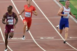 DAN001 - Beijing, -, CHINA : (L-R) Qatar's Femi Ogunode, China's Zhang Peimeng and Britain's Richard Kilty compete in the heats of the men's 100 metres athletics event at the 2015 IAAF World Championships at the "Bird's Nest" National Stadium in Beijing on August 22, 2015. AFP PHOTO / PEDRO UGARTE