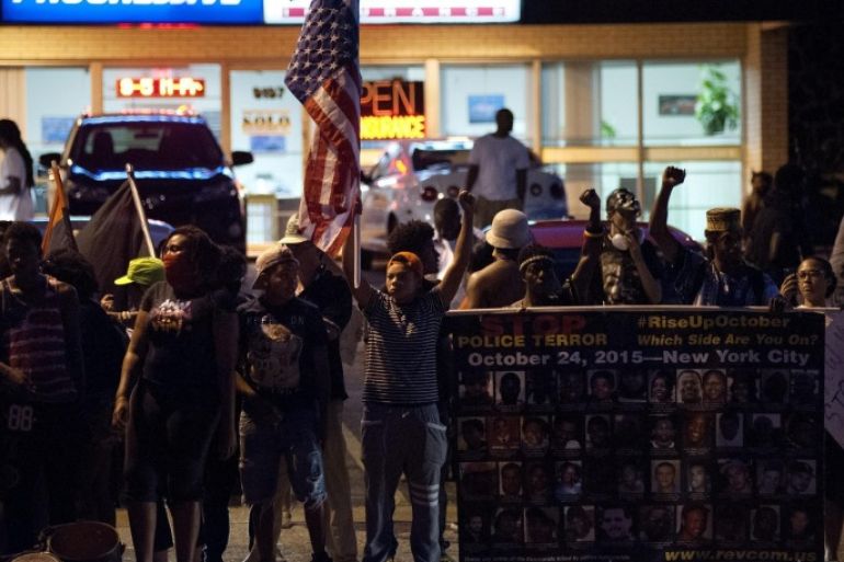 Protesters line West Florissant Avenue to mark the one-year anniversary of the death of Ferguson teenager Michael Brown Jr. in Ferguson, Missouri, USA, 10 August 2015. Protesters gathered to mark the one-year anniversary of the death of Ferguson teenager Michael Brown during an altercation with former Ferguson police officer Darren Wilson. Local authorities declared a state of emergency on 10 August 2015 in the wake of violence that erupted in Ferguson, Missouri on the anniversary of the shooting death of unarmed African-American teenager Michael Brown by a white police officer.