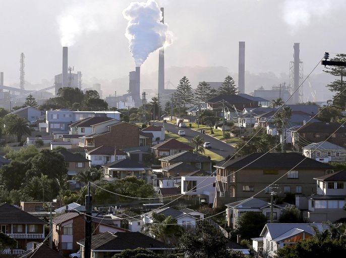 FILE - In this July 2, 2014 file photo, smoke billows out of a chimney stack of steel works factories in Port Kembla, south of Sydney. Australia's government repealed a much-maligned carbon tax on the nation's worst greenhouse gas polluters on Thursday, July 17, 2014, ending years of contention over a measure that became political poison for the lawmakers who imposed it. The Senate voted 39 to 32 to axe the 24.15 Australian dollar ($22.60) tax per metric ton of carbon dioxide that was introduced by the center-left Labor government in July 2012. (AP Photo/Rob Griffith, File)