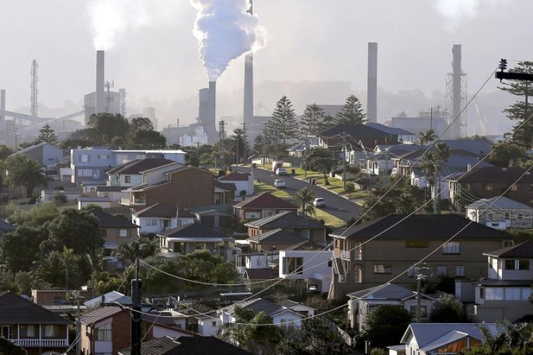 FILE - In this July 2, 2014 file photo, smoke billows out of a chimney stack of steel works factories in Port Kembla, south of Sydney. Australia's government repealed a much-maligned carbon tax on the nation's worst greenhouse gas polluters on Thursday, July 17, 2014, ending years of contention over a measure that became political poison for the lawmakers who imposed it. The Senate voted 39 to 32 to axe the 24.15 Australian dollar ($22.60) tax per metric ton of carbon dioxide that was introduced by the center-left Labor government in July 2012. (AP Photo/Rob Griffith, File)