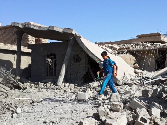 Iraqi boys walk among the rubble of a building damaged in an apparent airstrike carried out by the Iraqi army on Fallujah, Iraq, 09 August 2015. According to local medical sources, at least four people were killed, and dozens of others wounded in airstrikes targeting different districts in the Iraqi city, which remain in the hands of fighters from the jihadist militant group calling themselves the Islamic State (IS).