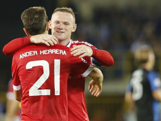 Manchester United's Ander Herrera (L) celebrates with teammate Wayne Rooney after scoring a goal during the UEFA Champions League play-off round second leg soccer match between Club Brugge and Manchester United held at the Jan Breyddel stadium in Bruges, Belgium, 26 August 2015.