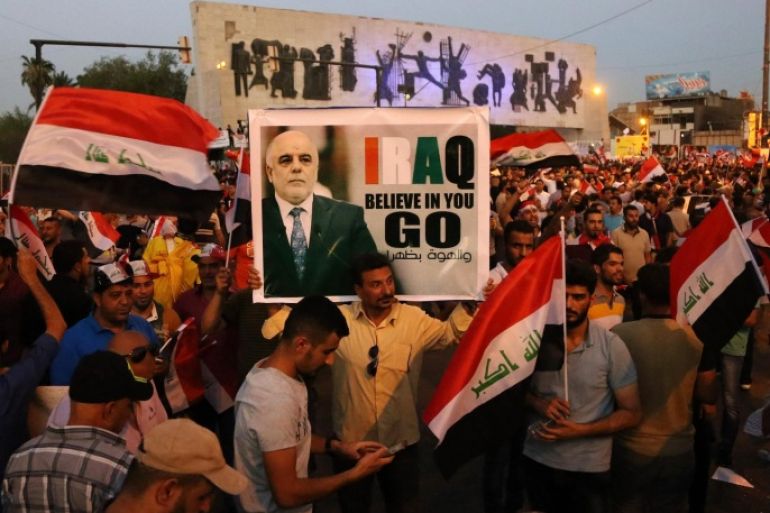 Demonstrators chant pro-Iraqi Prime Minister Haider al-Abadi, in the poster, during a demonstration at Tahrir Square in Baghdad, Iraq, Friday, Aug. 21, 2015. Thousands rallied in Iraq's capital and a string of other cities to press demands for reforms, better services and an end to corruption. (AP Photo/Karim Kadim)