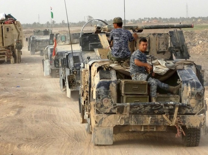 Iraqi security forces ride military vehicles on the outskirts of Ramadi August 6, 2015. After only modest gains in the first few weeks of their drive to retake Anbar province, Iraqi government forces have given up hopes of swift advances against Islamic State militants.  REUTERS/Stringer NO ARCHIVES