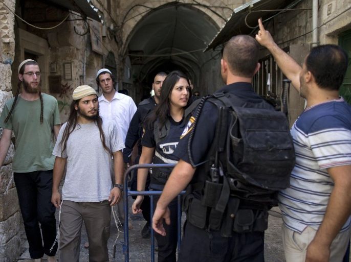 Israeli border police guard right wing Jews coming out of the All-Aqsa compound, against a protesting Palestinian muslim (R), shouting 'God is great and Al-Aqsa is ours', at the entrance to the Al-Aqsa mosque compound in the Old city of Jerusalem, Israel, 09 August 2015. Tension escalates at the al-Aqsa compound as more Jewish right-wing extremists are trying to pray inside the compound. The area houses the mosque, considered the third-holiest site in Islam, but it is also the site of the ruins of the biblical Jewish temple and is the most sacred site in Judaism.