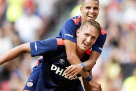 PSV Eindhoven players Luuk de Jong (bottom) and Adam Maher celebrate Maher's 3-0 during the Dutch super cup match between the league champion (PSV) and the national cup winner (FC Groningen), in Amsterdam, Netherlands, 02 August 2015.