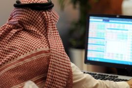 A Saudi investor monitors the stock exchange at the Al-Bilad Saudi Bank on June 15, 2015 in the capital Riyadh. Saudi Arabia's stock exchange allowed foreign investors to trade shares for the first time, boosting efforts by the world's top oil exporter to become a major global capital market. AFP PHOTO / FAYEZ NURELDINE