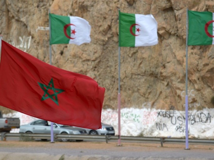 TO GO WITH AFP STORY BY JALAL AL-MAKHFIA picture taken on September 13, 2013, shows Moroccan and Algerian flags in Saidia, at the border between the two countries. The border, that is officially closed since 1994, was not hermetic at all but Algerian authorities launched an intensive campaign last June to clamp down on fuel smugglers. AFP PHOTO/FADEL SENNA