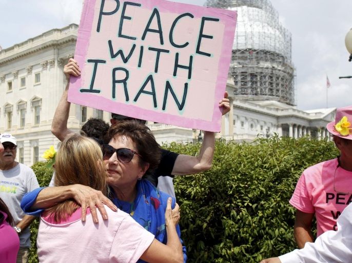 Rep. Jan Schakowsky (D-IL) hugs a Code Pink activist at an event of activists delivering more than 400,000 petition signatures to Capitol Hill in support of the Iran nuclear deal in Washington July 29, 2015. Secretary of State John Kerry intensified efforts on Tuesday to beat back criticism of the Iran nuclear deal and convince U.S. lawmakers that rejecting it would give Tehran a fast track to a weapon and access to billions of dollars from collapsed sanctions. REUTERS/Yuri Gripas