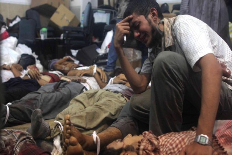 A man grieves as he looks at one of many bodies laid out in a make shift morgue after Egyptian security forces stormed two huge protest camps at the Rabaa al-Adawiya and Al-Nahda squares where supporters of ousted president Mohamed Morsi were camped, in Cairo, on August 14, 2013. Egypt's bloody crackdown on supporters of Morsi triggered widespread condemnation as the international community reacted with alarm to the deepening crisis. The action has resulted in more than 120 deaths, according to.