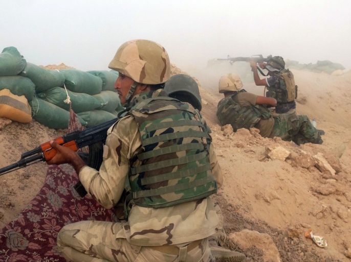 In this Thursday, Aug. 6, 2015 photo, Iraqi Army soldiers clash with Islamic State group militants at the front line in the eastern suburbs of Ramadi, Anbar province, Iraq. The contested Iraqi city of Ramadi fell to the Islamic State group on May 17, as Iraqi forces abandoned their weapons and armored vehicles to flee the provincial capital in a major loss despite intensified U.S.-led airstrikes.(AP Photo)