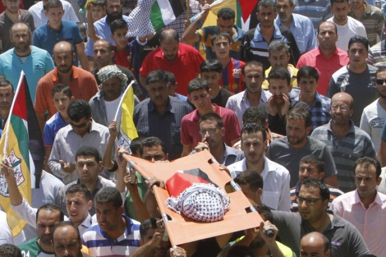 Mourners carry the body of 18-month-old Palestinian baby Ali Dawabsheh, who was killed after his family's house was set on fire in a suspected attack by Jewish extremists in Duma village near the West Bank city of Nablus July 31, 2015. Suspected Jewish attackers torched a Palestinian home in the occupied West Bank on Friday, killing an 18-month-old toddler and seriously injuring three other family members, an act that Israel's prime minister described as terrorism. REUTERS/Abed Omar Qusini
