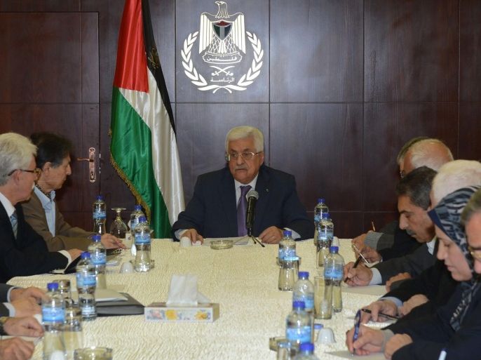 A handout photograph supplied by the Palestinian Authority shows Palestinian President Mahmoud Abbas (C) as he presides over a meeting of the Palestinian Authority Central Committee meeting in the West Bank town of Ramallah, 29 December 2014. According to reports, Abbas spoke with US Secretary of State John Kerry by telephone and informed him the Palestinians intend to submit a final draft of a statehood resolution to the United Nations on 29 December 2014 calling for a peace deal with Israel within a year with an 'end to occupation' of Palestinian territories by the end of 2017. The USA has said it will veto the resolution. EPA/OSAMA FALAH/HANDOUT