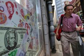 (FILE) A file photo dated 13 September 2010 showing a man walking past oversized Chinese yuan (RMB) notes, US bank notes and other foreign currency seen out side a foreign exchange in Hong Kong, China. China's central bank on 12 August 2015 devalued the yuan for the second time in two days, to aid a slowing economy. The People's Bank of China unexpectedly adjusted its daily reference exchange rate by a further 1.6 per cent, setting it at 6.3306 to the US dollar. On 11 August, the bank cut the rate by 1.9 per cent, triggering the biggest one-day slide in yuan value against the dollar since China unified official and market exchange rates in 1994. EPA/YM YIK *** Local Caption *** 02333459