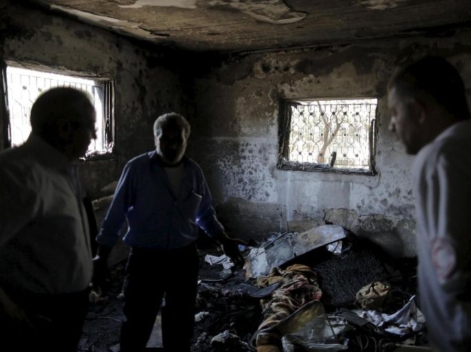 Palestinians inspect a house which was set on fire in a suspected attack by Jewish extremists in Duma village near the West Bank city of Nablus July 31, 2015. Suspected Jewish attackers torched a Palestinian home in the occupied West Bank on Friday, killing an 18-month-old toddler and seriously injuring three other family members, an act that Israel's prime minister described as terrorism. REUTERS/Ammar Awad