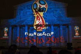 The official logo for the 2018 FIFA World Cup is presented on the facade of the Bolshoi Theatre in Moscow, Russia, Wednesday, Oct. 29, 2014. FIFA President Sepp Blatter has revealed the logo for the 2018 World Cup in Russia - with the help of a crew of cosmonauts. The logo depicts the World Cup trophy in red and blue, colors from the Russian flag, with gold trim. (AP Photo/Pavel Golovkin)