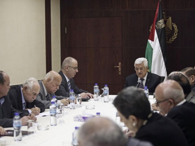 FILE - In this April 18, 2015, file photo, Palestinian President Mahmoud Abbas, center, chairs a meeting of the PLO executive committee in the West Bank city of Ramallah. Documents recently leaked online detailing two attempts by Palestinian officials to misuse public funds have triggered outrage, highlighting the corruption and mismanagement critics say remains rampant in the Palestinian government. Palestinian Authority officials have defended their record on stamping out corruption, saying they’ve recovered millions of dollars in misspent funds. (AP Photo/Fadi Arouri, Pool, File)