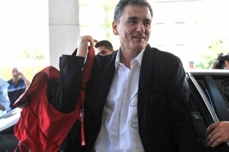 Greek Finance Minister Euclid Tsakalotos arrives for a meeting with senior negotiators at a hotel in Athens, on Friday, July 31, 2015. Greece's talks with its international creditors on a third bailout worth 85 billion euros ($93 billion) shifted into a higher gear on Friday, with lead negotiators from the European Union and International Monetary Fund meeting key ministers in Athens. (Giannis Kotsiaris/InTime News via AP) GREECE OUT