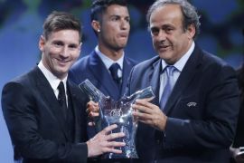 FC Barcelona's Lionel Messi (L) receives from UEFA president Michel Platini (R) his UEFA best player in Europe for 2014-2015 Award during the draw ceremony for the UEFA Champions League group stage at Grimaldi Forum in in Monte Carlo, Monaco, 27 August 2015.