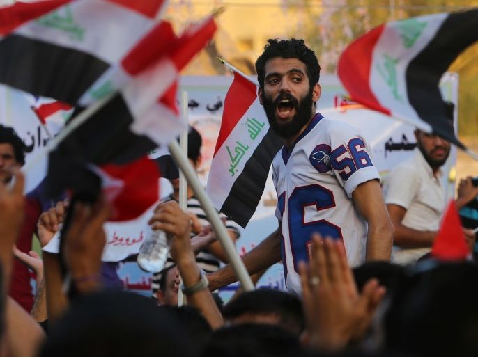 Protesters chant slogans during a demonstration in Basra, 340 miles (550 kilometers) southeast of Baghdad, Iraq, Friday, Aug. 21, 2015. Thousands rallied in Iraq's capital and a string of other cities to press demands for reforms, better services and an end to corruption. (AP Photo/Nabil al-Jurani)