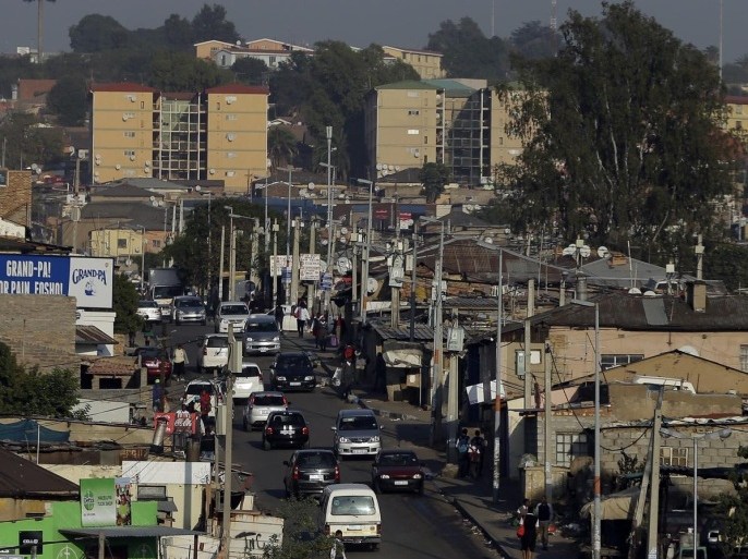A street scene at Alexandra township in Johannesburg, South Africa, Thursday, May 7, 2015. A densely populated Alexandra township, borders and contrasts Sandton, the wealthiest suburb in South Africa. (AP Photo/Themba Hadebe)