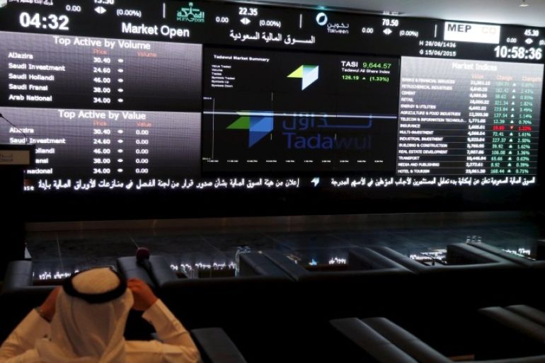 A trader monitors screens displaying stock information at the Saudi Stock Exchange (Tadawul) in Riyadh June 15, 2015. The chief executive of Saudi Arabia's stock exchange said on Monday he expected a flurry of licenses allowing the first foreign investors to buy shares there in coming weeks. To match Interview SAUDI-STOCKEXCHANGE/ REUTERS/Faisal Al Nasser